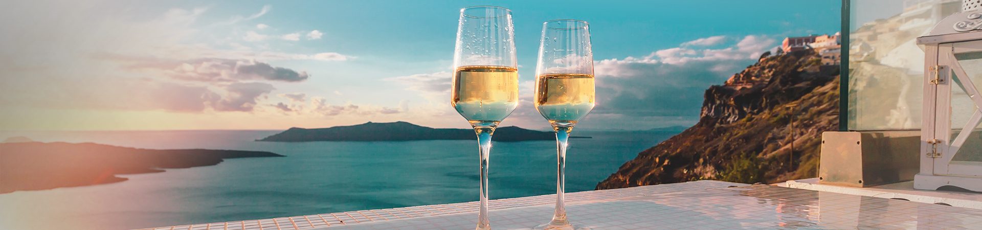 Luxury escapes - two wine glasses by the edge of a pool