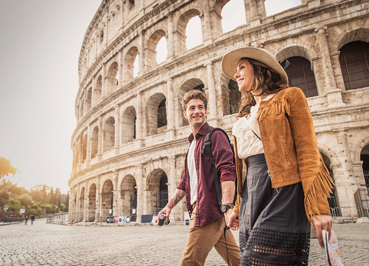 Young couple walking outside the Colosseum